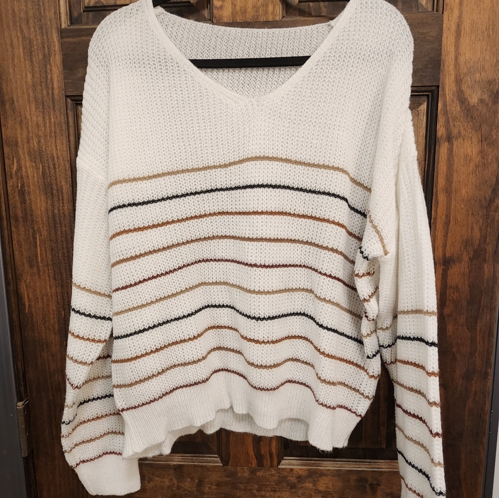 White Sweater with brown and black stripes. Perfect with leggings and boots.